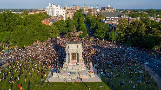 Mandatory Credit: Photo by Steve Helber/AP/Shutterstock (10667306f)With a drone, a large group of protesters gather around the statue of Confederate General Robert E. Lee on Monument Avenue near downtown, in Richmond, Va. The crowd protesting police brutality chanted 