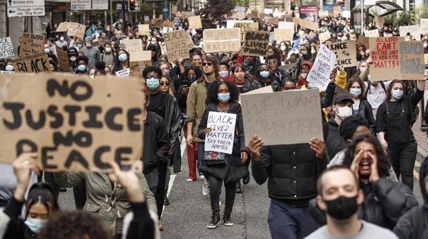 People take part in a Black Lives Matter protest rally in Manchester, England, Sunday, June 7, 2020, in response to the recent killing of George Floyd by police officers in Minneapolis, USA, that has led to protests in many countries and across the US. (Danny Lawson/PA via AP)
