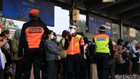 Petugas mengarahkan penumpang untuk menjalankan protokol kesehatan.