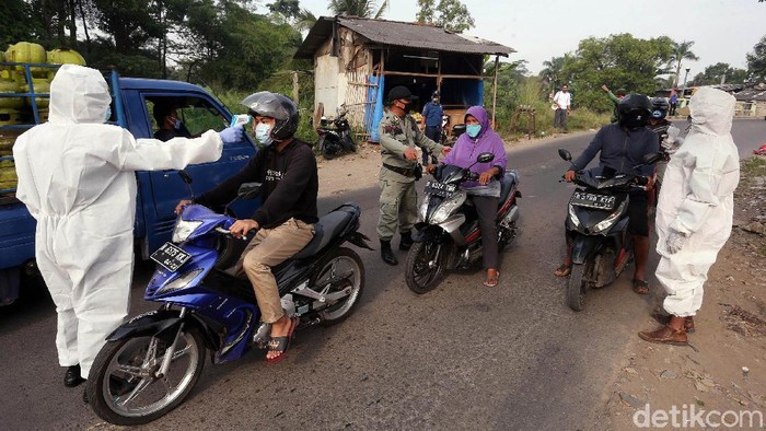 Check point PSBB di Kota Bekasi terus dilakukan untuk mencegah penyebaran COVID-19. Kali ini, petugas melakukan pemeriksaan dengan memakai APD.