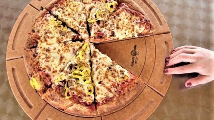 Time for snack. Happy students eating pizza and chatting at home