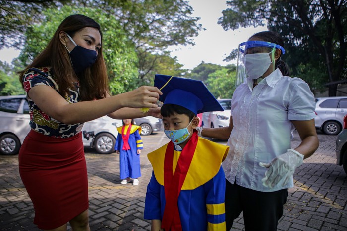 Siswa sekolah Stella Maris bersiap sebelum mengikuti acara kelulusan secara drive thru di Stella Maris School, Kelapa Dua, Kabupaten Tangerang, Banten, Selasa (9/6/2020). Kegiatan wisuda tersebut digelar secara drive thru guna menghindari kerumunan yang bisa menjadi medium penyebaran COVID-19. ANTARA FOTO/Fauzan/foc.