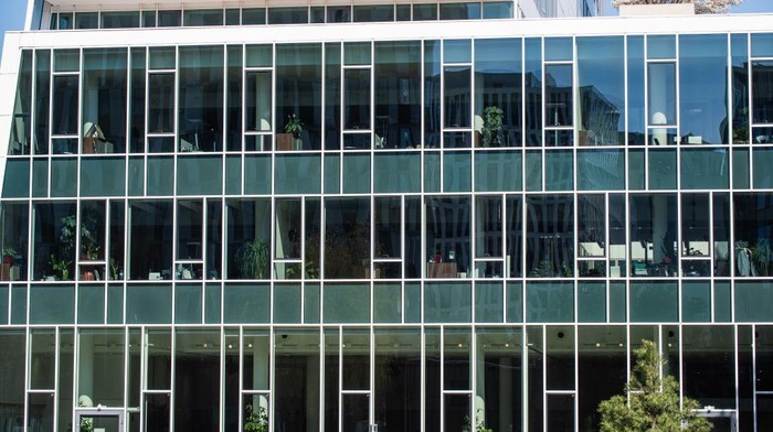 ERDING, GERMANY - MARCH 18: Employees of a post office have protected themselves with plastic foil in their post office on March 18, 2020 in Erding, Germany. Everyday life in Germany has become fundamentally altered as authorities tighten measures to stem the spread of the coronavirus. Public venues such as bars, clubs, museums, cinemas, schools, daycare centers and universities have closed. Many businesses are resorting to home office work for their employees. And travel across the border to most neighbouring countries is severely restricted.  (Photo by Alexander Hassenstein/Getty Images)