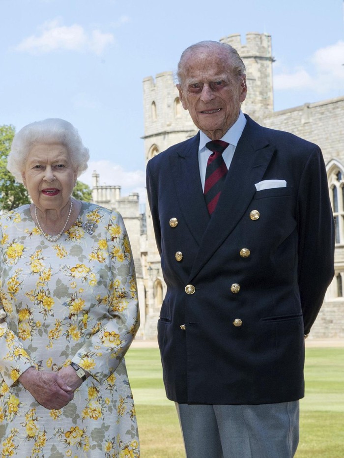 Britains Queen Elizabeth II and Prince Philip the Duke of Edinburgh pose for a photo June 1, 2020, in the quadrangle of Windsor Castle, in Windsor, England, ahead of his 99th birthday on Wednesday, June 10. The Queen is wearing an Angela Kelly dress with the Cullinan V diamond brooch, while Prince Philip is wearing a Household Division tie. (Steve Parsons/Pool via AP)