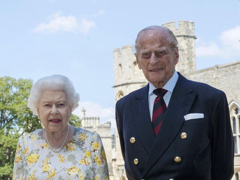 Britain's Queen Elizabeth II and Prince Philip the Duke of Edinburgh pose for a photo June 1, 2020, in the quadrangle of Windsor Castle, in Windsor, England, ahead of his 99th birthday on Wednesday, June 10. The Queen is wearing an Angela Kelly dress with the Cullinan V diamond brooch, while Prince Philip is wearing a Household Division tie. (Steve Parsons/Pool via AP)