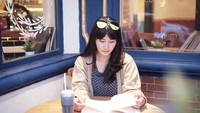 Tak hanya berpose di pinggir kolam renang, Yossy juga kerap berpose dan mengabadikan momennya di berbagai kafe cantik dan kekinian. Seperti ketika dirinya menikmati segelas minuman segar sambil baca buku. Foto: Instagram @yossykartikaas