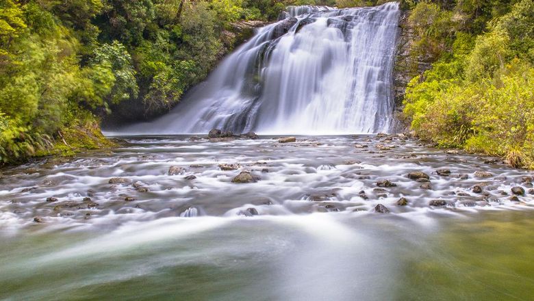 Long exposure image of a waterfall in lush rainforest of Te Urewera National Park in New Zealand