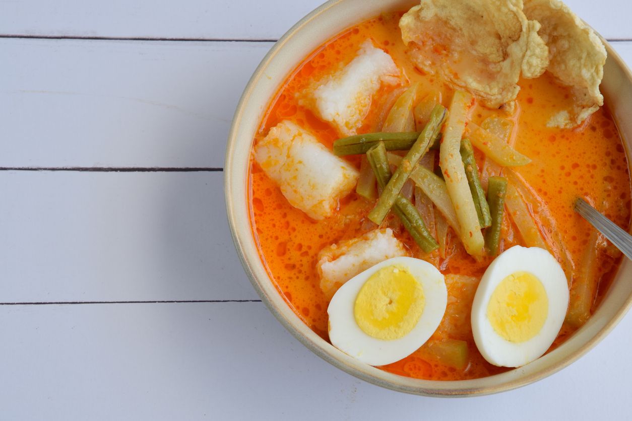 Lontong Sayur, Indonesian cuisine. Compressed rice cake with vegetables (chayote and yard long bean) cooked in coconut milk and spices. Served with boiled egg and Emping cracker