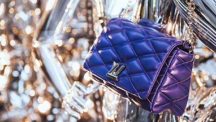 Milan, Italy - December 15, 2015: Louis Vuitton luxury leather bag in the shop window in Milans fashion district Via Monte Napoleone showcasing the latest fashion news in an original way.