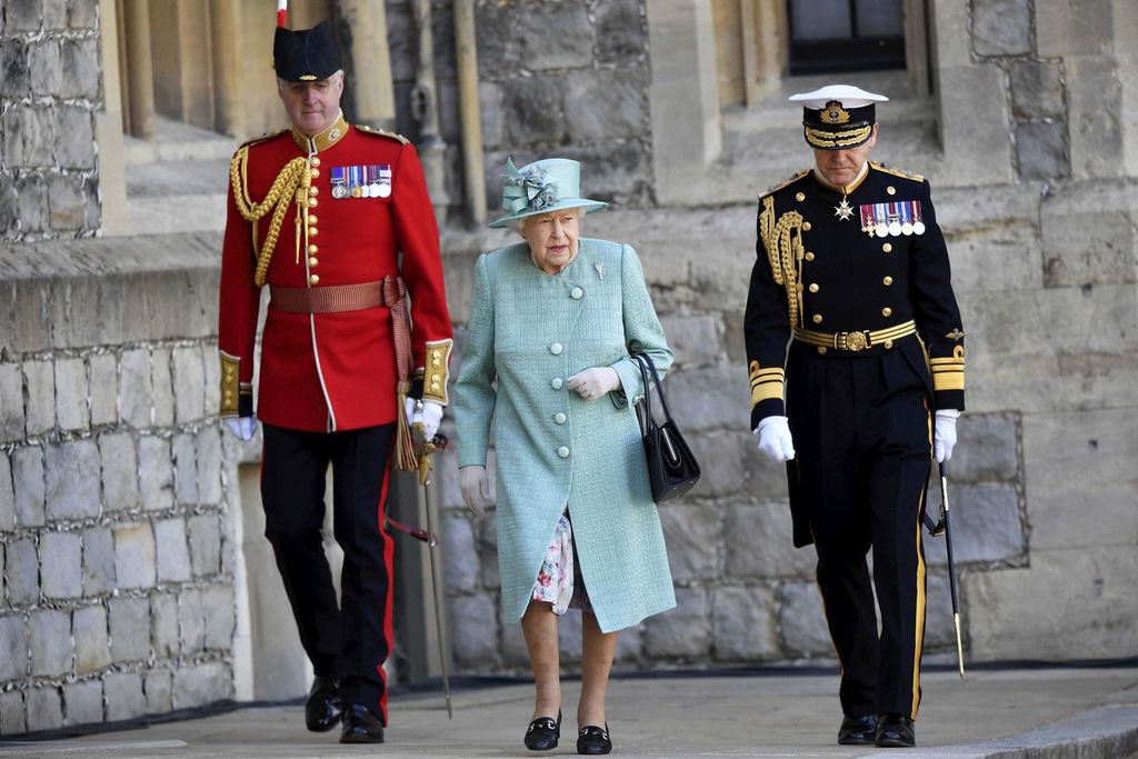 Britain's Queen Elizabeth II looks out during a ceremony to mark her official birthday at Windsor Castle in Windsor, England, Saturday June 13, 2020. Queen Elizabeth II's birthday is being marked with a special ceremony taking care for social distancing by everyone present amid the coronavirus pandemic. The Queen celebrates her 94th birthday this year. (Paul Edwards/Pool via AP)