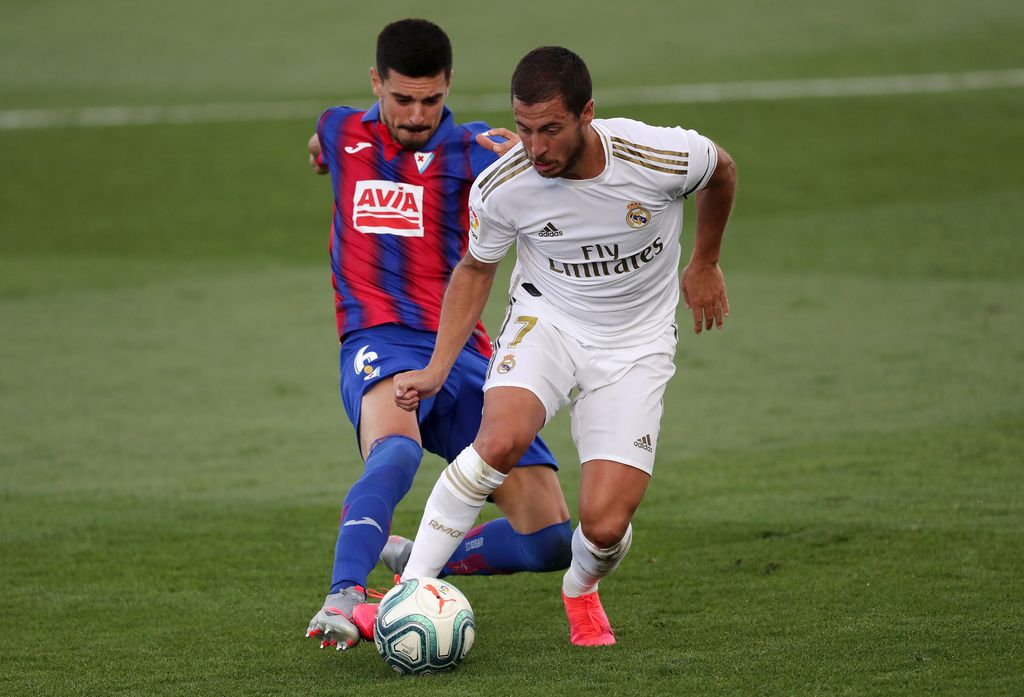Eden Hazard MADRID, SPAIN - JUNE 14: Segio Alvarez of Eibar battles for possession with Eden Hazard of Real Madrid during the Liga match between Real Madrid CF and SD Eibar SAD at Estadio Alfredo Di Stefano on June 14, 2020 in Madrid, Spain. (Photo by Gonzalo Arroyo Moreno/Getty Images)