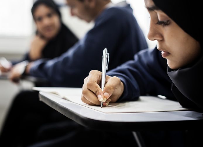 Muslim woman reading from the quran stock photo