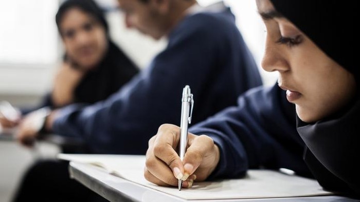 Muslim woman reading from the quran stock photo