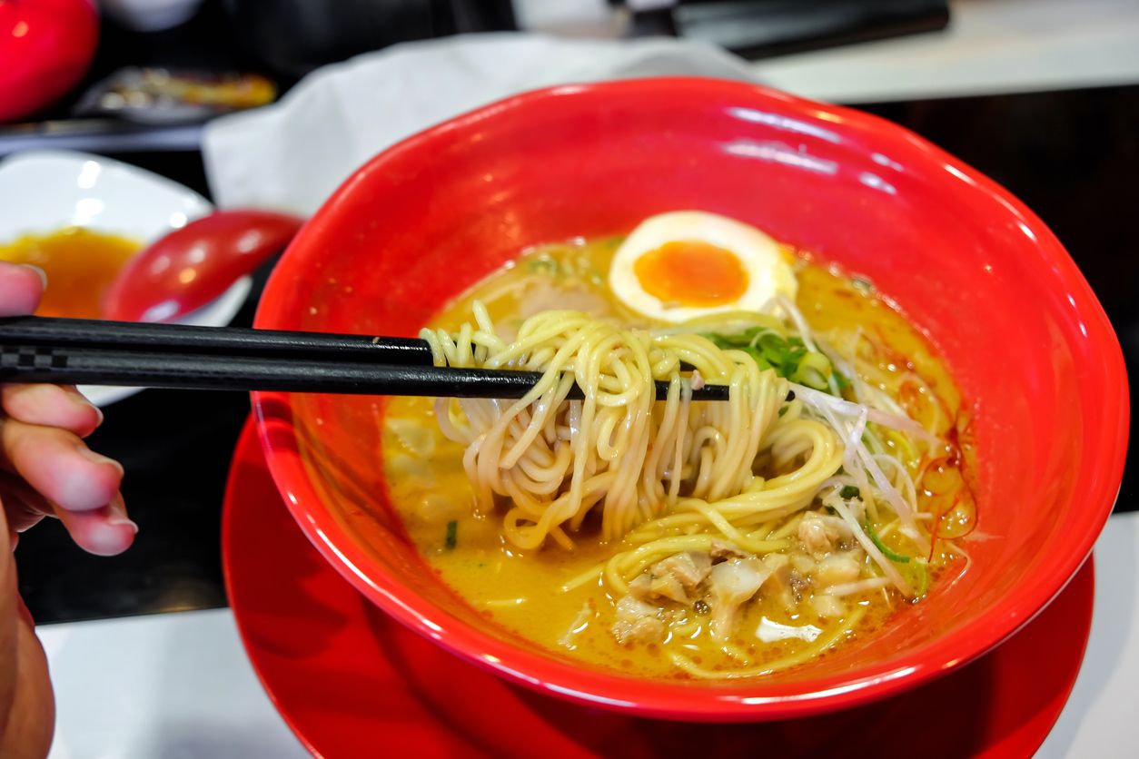 Close up shot of miso noodle ramen with chopped pork meat and soft boiled egg