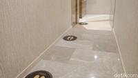 Jaga jarak juga berlaku di antrean toilet.