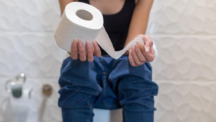 1124475540 Woman sitting in the toilet