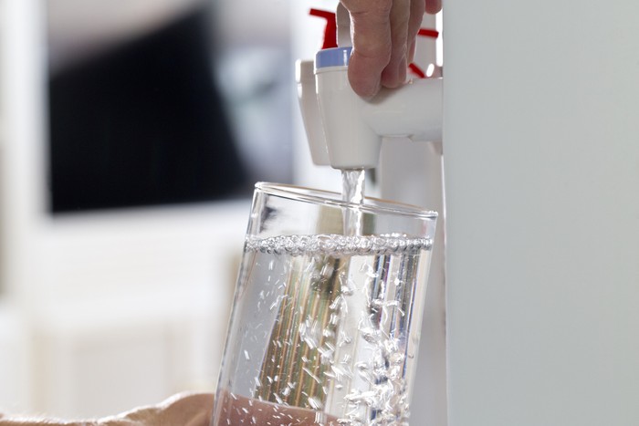 585609666 Glass being filled at a water cooler