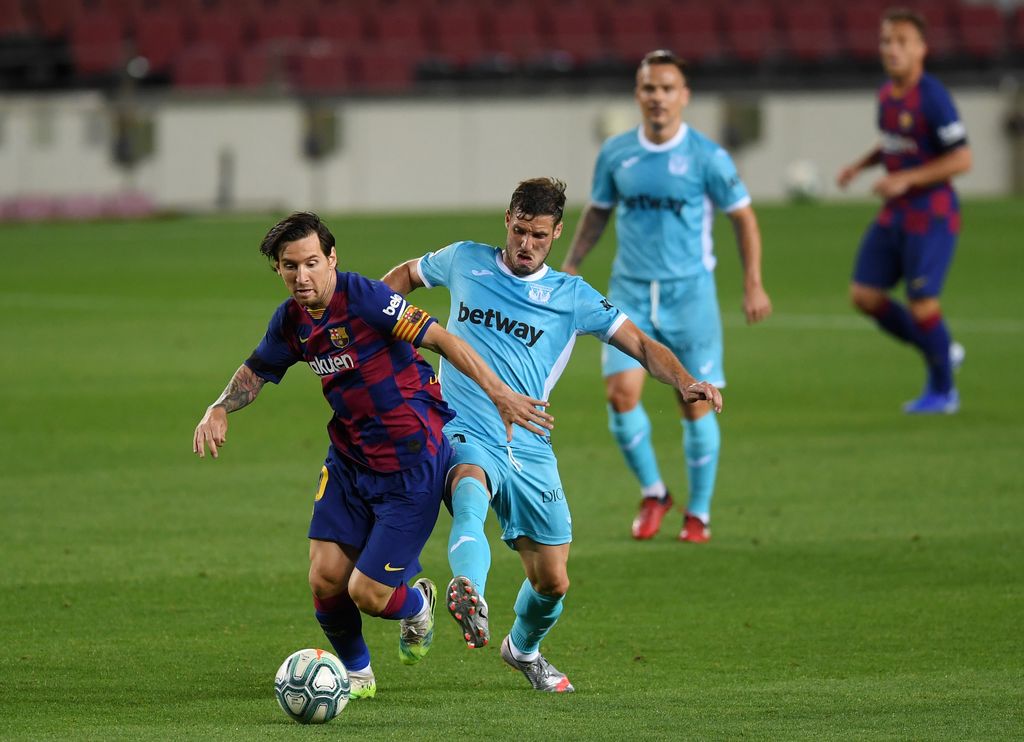 Barcelona BARCELONA, SPAIN - JUNE 16: Lionel Messi of Barcelona battles for possession with Ruben Perez of Leganes during the Liga match between FC Barcelona and CD Leganes at Camp Nou on June 16, 2020 in Barcelona, Spain. (Photo by Alex Caparros/Getty Images)