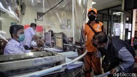 Pembatas plastik dipasang untuk menghindari kontak langsung antara petugas dengan warga.