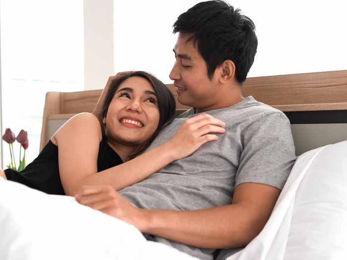 couple Young loving couple in bed. Happy couple relaxing in bed.