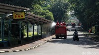 Mobil pemadam kebakaran menyusuri area-area yang biasanya dilintasi para pengunjung Ragunan. Area-area itu kemudian disemprot disinfektan.