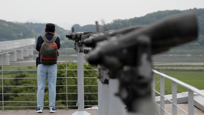 A visitor watches the northern side from the Imjingak Pavilion in Paju, South Korea, Thursday, June 18, 2020. Relations between the Koreas have been strained since a second Kim-Trump summit in early 2019 fell apart due to wrangling over the sanctions. (AP Photo/Lee Jin-man)