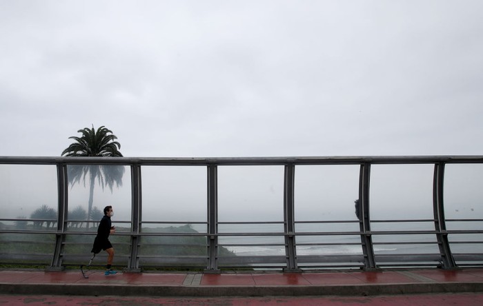 1220782653 LIMA, PERU - JUNE 17: Peruvian Para badminton player Pedro Pablo de Vinatea Pepe runs through the streets of Miraflores during government-ordered coronavirus lockdown on June 13, 2020 in Lima, Peru. As he awaits for an invitation to compete in Tokyo Paralympics, three-time Pan American champion De Vinatea continues his daily routine in isolation during the coronavirus lockdown in Peru. The next summer Paralympics will be the first to include para badminton as an official competition (Photo by Raul Sifuentes/Getty Images)