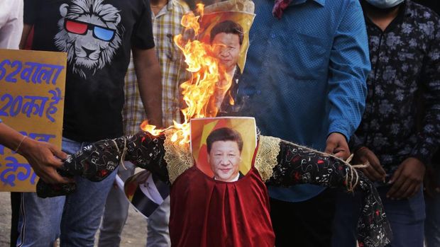 Indians burn an effigy of Chinese President Xi Jinping during a protest against China in Ahmedabad, India, Thursday, June 18, 2020. Twenty Indian troops were killed in a clash with Chinese soldiers in the Galwan Valley area Monday night that was the deadliest conflict between the sides in 45 years. (AP Photo/Ajit Solanki)