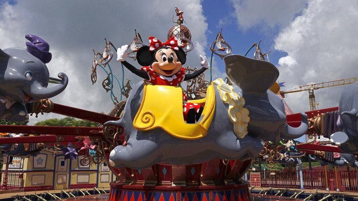 A visitor enjoys the swing ride at the Yomiuriland amusement park in Tokyo, Tuesday, June 16, 2020. The park has been closed since the end of March due to the new coronavirus, has taken measures to prevent infections and reopened limited attractions. (AP Photo/Eugene Hoshiko)