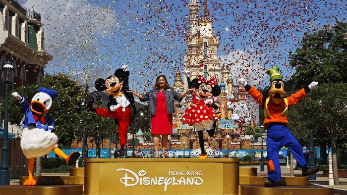 The iconic cartoon character Minnie Mouse waves to visitors at the Hong Kong Disneyland on Thursday, June 18, 2020. Hong Kong Disneyland on Thursday opened its doors to visitors for the first time in nearly five months, at a reduced capacity and with social distancing measures in place. The theme park closed temporarily at the end of January due to the coronavirus outbreak, and is the second Disney-themed park to re-open worldwide, after Shanghai Disneyland. (AP Photo/Kin Cheung)