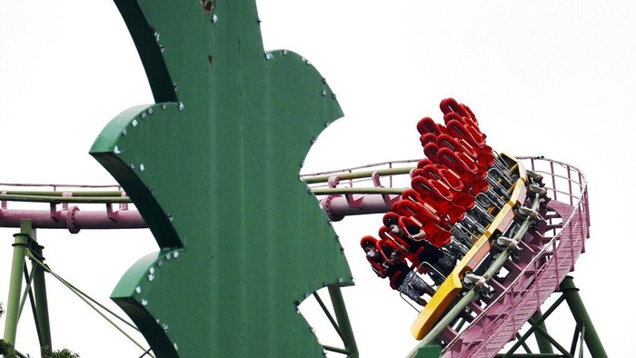 Visitors ride the roller coaster at the newly-opened Yomiuriland amusement park in Tokyo, Tuesday, June 16, 2020. The park has been closed since the end of March as a part of the precautions to help curb the spread of the  coronavirus. (AP Photo/Eugene Hoshiko)