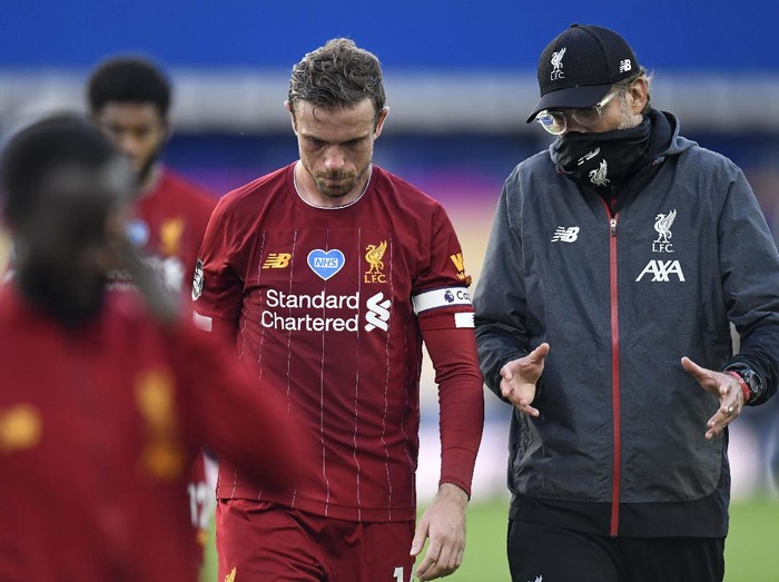 Liverpool's manager Jurgen Klopp and Liverpool's Jordan Henderson leave the field at the end of the English Premier League soccer match between Everton and Liverpool at Goodison Park in Liverpool, England, Sunday, June 21, 2020. (Peter Powell/Pool via AP)