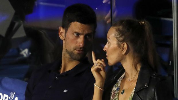 Serbia's Novak Djokovic, left, speaks with his wife Jelena during a final match of the Adria Tour charity tournament, between Austria's Dominic Thiem and Serbia's Filip Krajinovic, in Belgrade, Serbia, Sunday, June 14, 2020. (AP Photo/Darko Vojinovic)