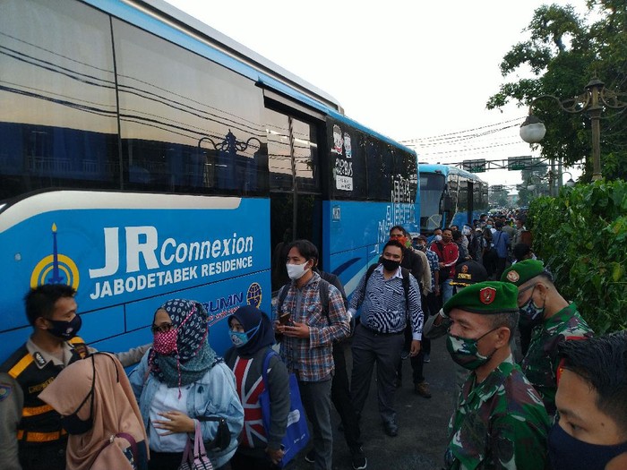Warga hendak menaiki bus gratis dari Stasiun Bogor arah Jakarta.