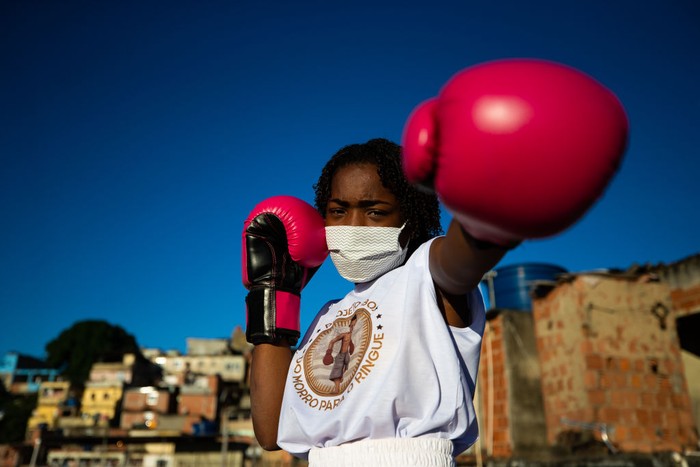RIO DE JANEIRO, BRAZIL - JUNE 18: Residents of the Tuiuti Community, located in the Benfica neighborhood receive food donations amidst the coronavirus (COVID-19) pandemic on June 18, 2020 in Rio de Janeiro, Brazil. A partnership between the social project 'Mutirao Presente' and the Boxing project 