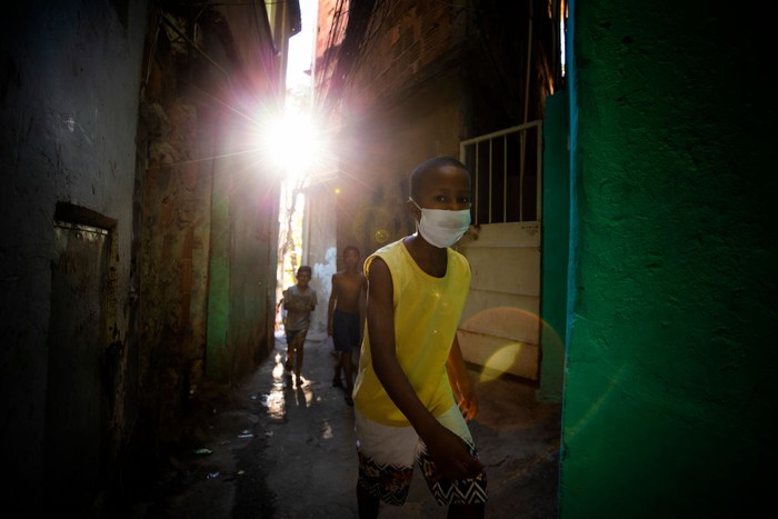 1221965161 RIO DE JANEIRO, BRAZIL - JUNE 18: Residents of the Tuiuti Community, located in the Benfica neighborhood receive food donations amidst the coronavirus (COVID-19) pandemic on June 18, 2020 in Rio de Janeiro, Brazil. A partnership between the social project 'Mutirao Presente' and the Boxing project