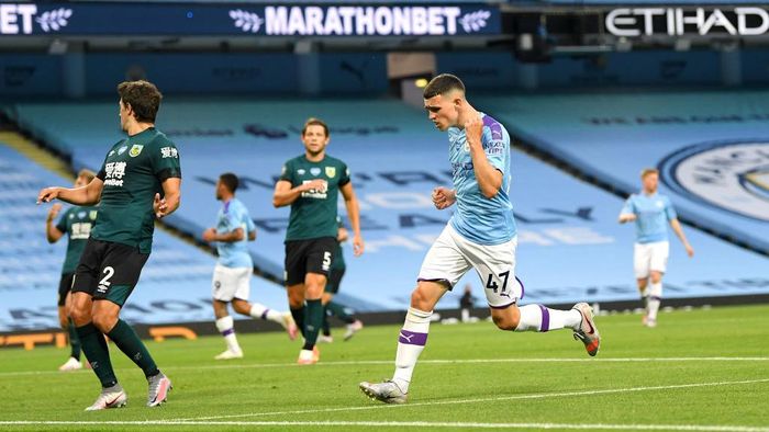 Phil Foden MANCHESTER, ENGLAND - JUNE 22: Phil Foden of Manchester City celebrates after scoring his teams fifth goal during the Premier League match between Manchester City and Burnley FC at Etihad Stadium on June 22, 2020 in Manchester, England. Football stadiums around Europe remain empty due to the Coronavirus Pandemic as Government social distancing laws prohibit fans inside venus resulting in all fixtures being played behind closed doors. (Photo by Michael Regan/Getty Images)
