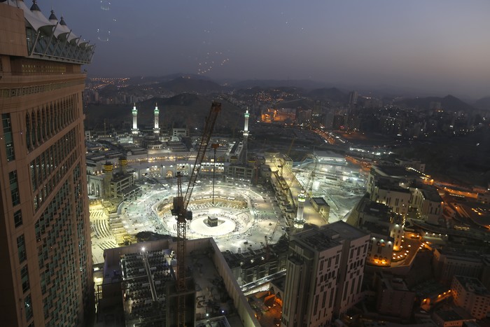 FILE - In this March 7, 2020 file photo, the sun sets at the site of the Grand Mosque, in the Muslim holy city of Mecca, Saudi Arabia, as authorities emptied Islams holiest site for sterilization over fears of the new coronavirus. This was supposed to be Saudi Arabias year to shine as host of the prestigious G20 gathering of world leaders. Instead, due to the pandemic, the gathering this November will likely be a virtual meet-up, stripping its host of the pomp that would have accompanied televised arrivals on Riyadhs tarmac. Even the upcoming hajj pilgrimage faces the possibility of being canceled or dramatically pared down. (AP Photo/Amr Nabil, File)