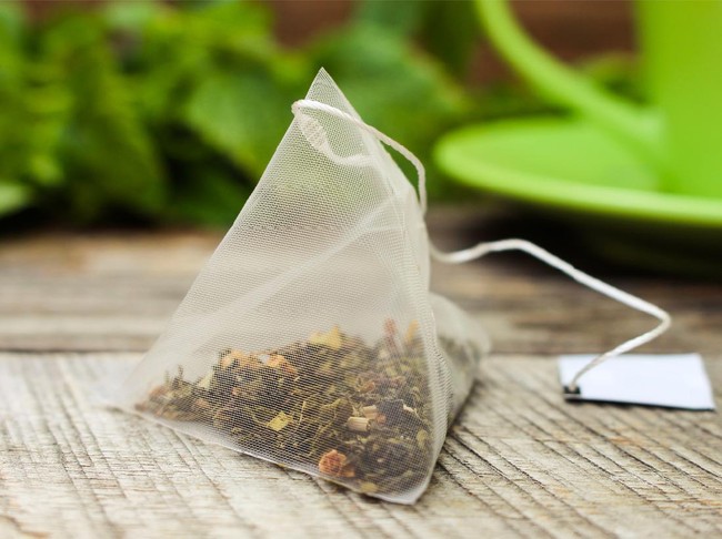 teh celup Tea bag on background of mint and and green cup