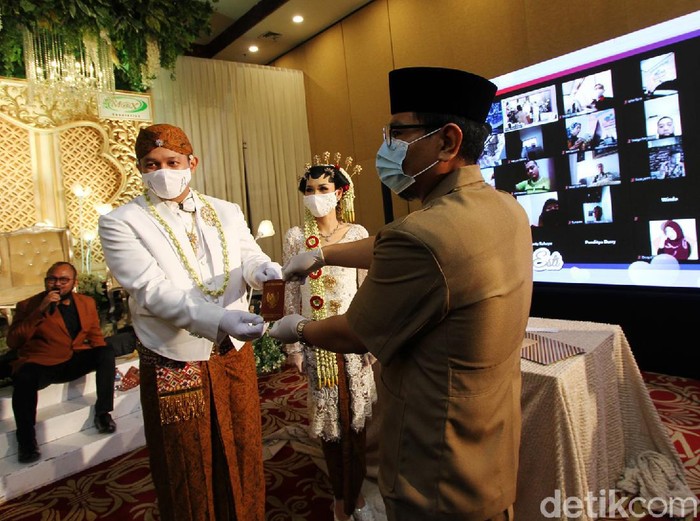 Melihat Prosesi Akad Nikah di Tengah Pandemi Pasangan pengantin Romdoni dan Dini Larasati menikah di KUA Cimanggis, Depok, Minggu (21/6). Prosesi akad nikah masih menggunakan protokol kesehatan COVID-19.