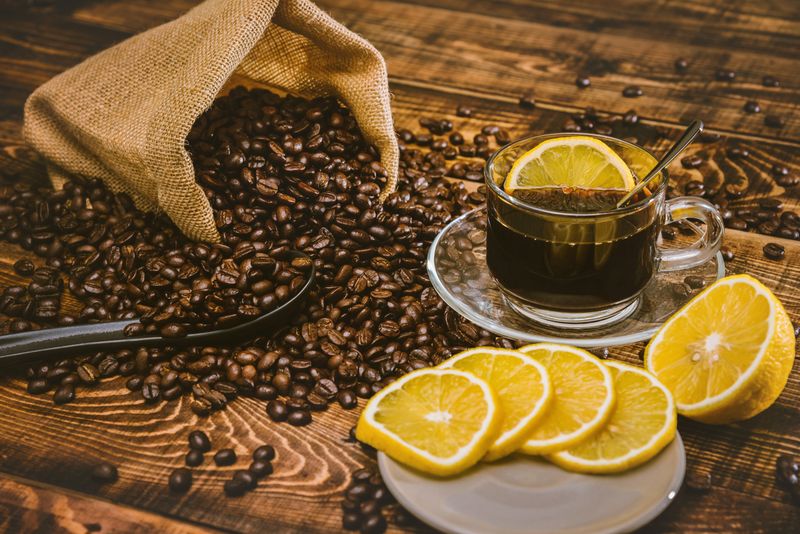 Coffee cup and beans on old kitchen table. Top view with copy space for your text. coffee bag and with sliced 