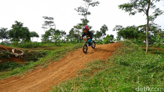 Seorang anak tengah asik bermain pushbike