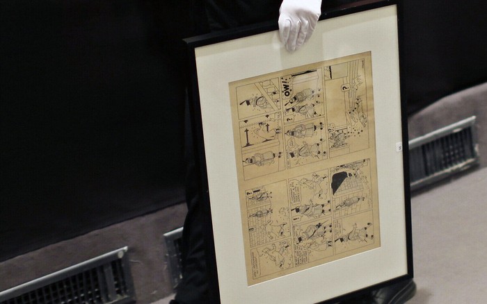 Komik Tintin FILE - In this May 29, 2010 file photo, a porter holds an inked and water-painted original panel from the 1938