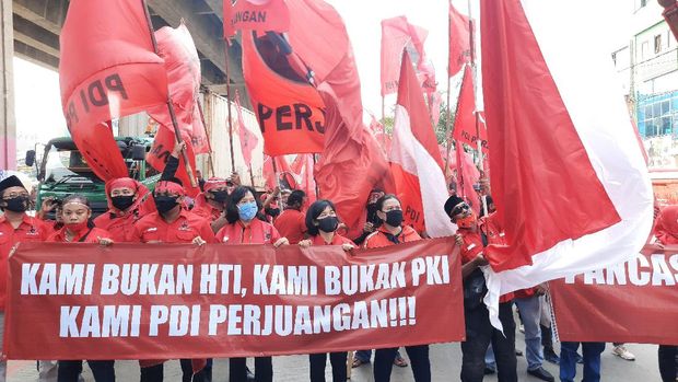 Massa DPC PDIP Jakut bentangkan spanduk di Jalan Yos Sudarso, Jakarta Utara, Jumat (26/6/2020).