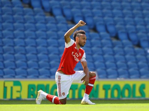 BRIGHTON, ENGLAND - JUNE 20: Pierre-Emerick Aubameyang of Arsenal takes a knee in support of the Black Lives Matter movement prior to the Premier League match between Brighton & Hove Albion and Arsenal FC at American Express Community Stadium on June 20, 2020 in Brighton, England. Football Stadiums around Europe remain empty due to the Coronavirus Pandemic as Government social distancing laws prohibit fans inside venues resulting in all fixtures being played behind closed doors. (Photo by Richard Heathcote/Getty Images)