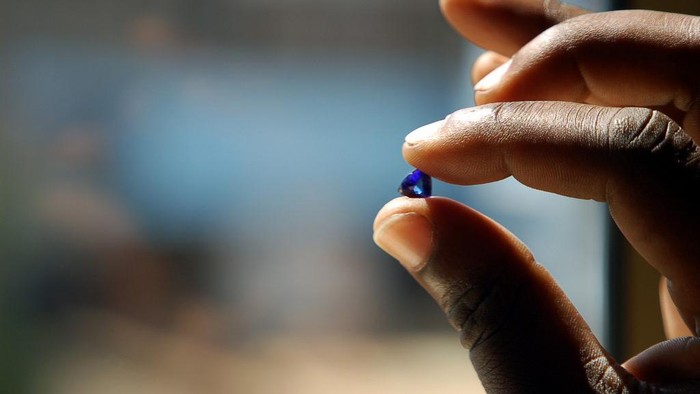 A Tanzanian tanzanite miner holds 09 June 2006 a gem worth locally 200 US dollars outside the Mererani mine, which runs 300 meters into the ground. In the United States, which accounts for 80 percent of the worlds consumption, 400 million dollars (317 million euros) worth of tanzanite jewelry is sold each year. Maasai herders first found the stone in 1967, prompting famed US jeweller Tiffany and Co. to call it 