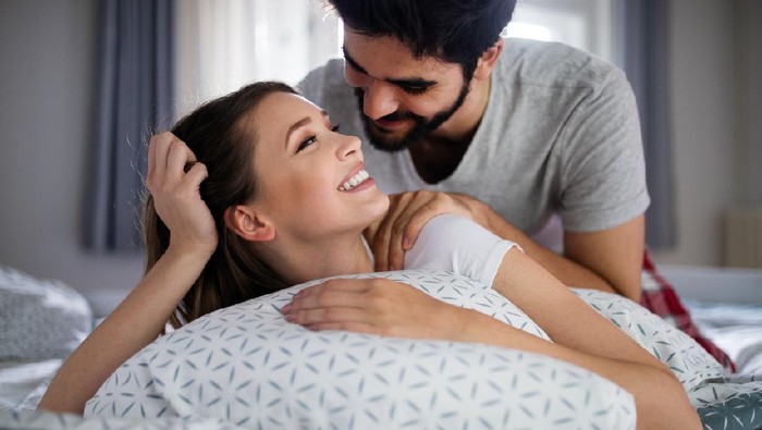 1181629929 Cheerful young happy couple making massage at home