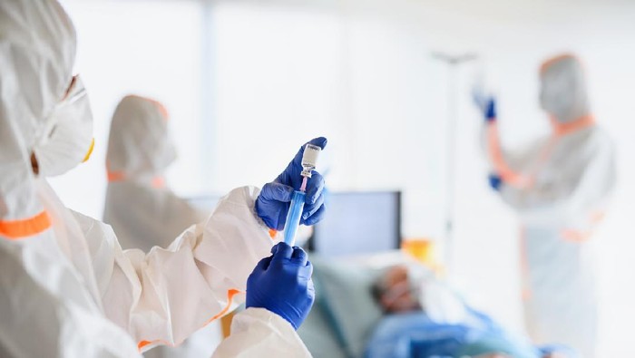 Doctors looking after infected patients in hospital, coronavirus concept.