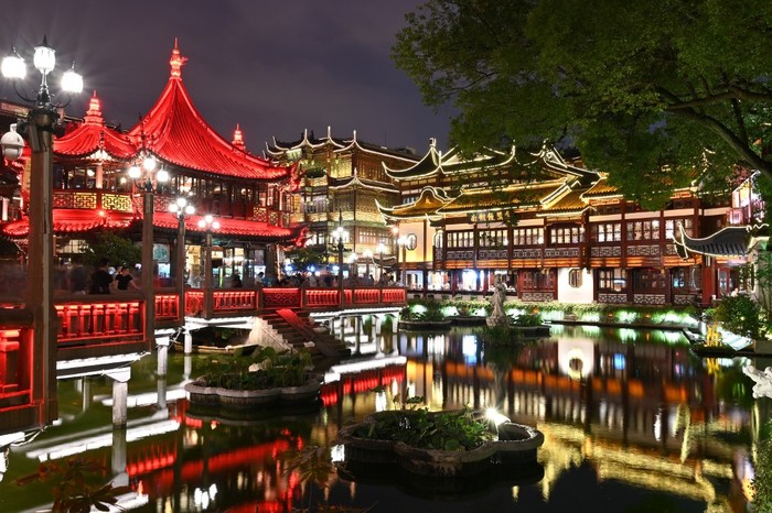 People walk on the streets of Yuyuan Garden in Shanghai, on June 7, 2019, the day of Dragon Boat Festival celebrations. (Photo by HECTOR RETAMAL / AFP)