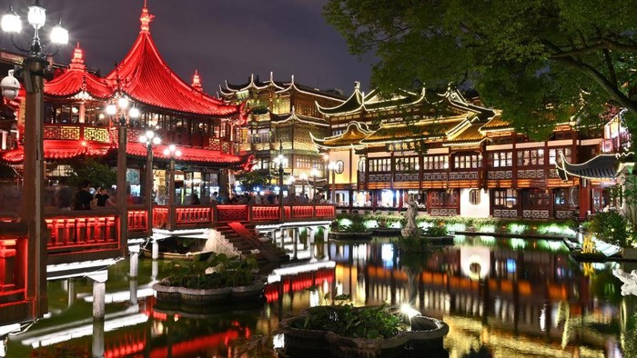 People walk on the streets of Yuyuan Garden in Shanghai, on June 7, 2019, the day of Dragon Boat Festival celebrations. (Photo by HECTOR RETAMAL / AFP)